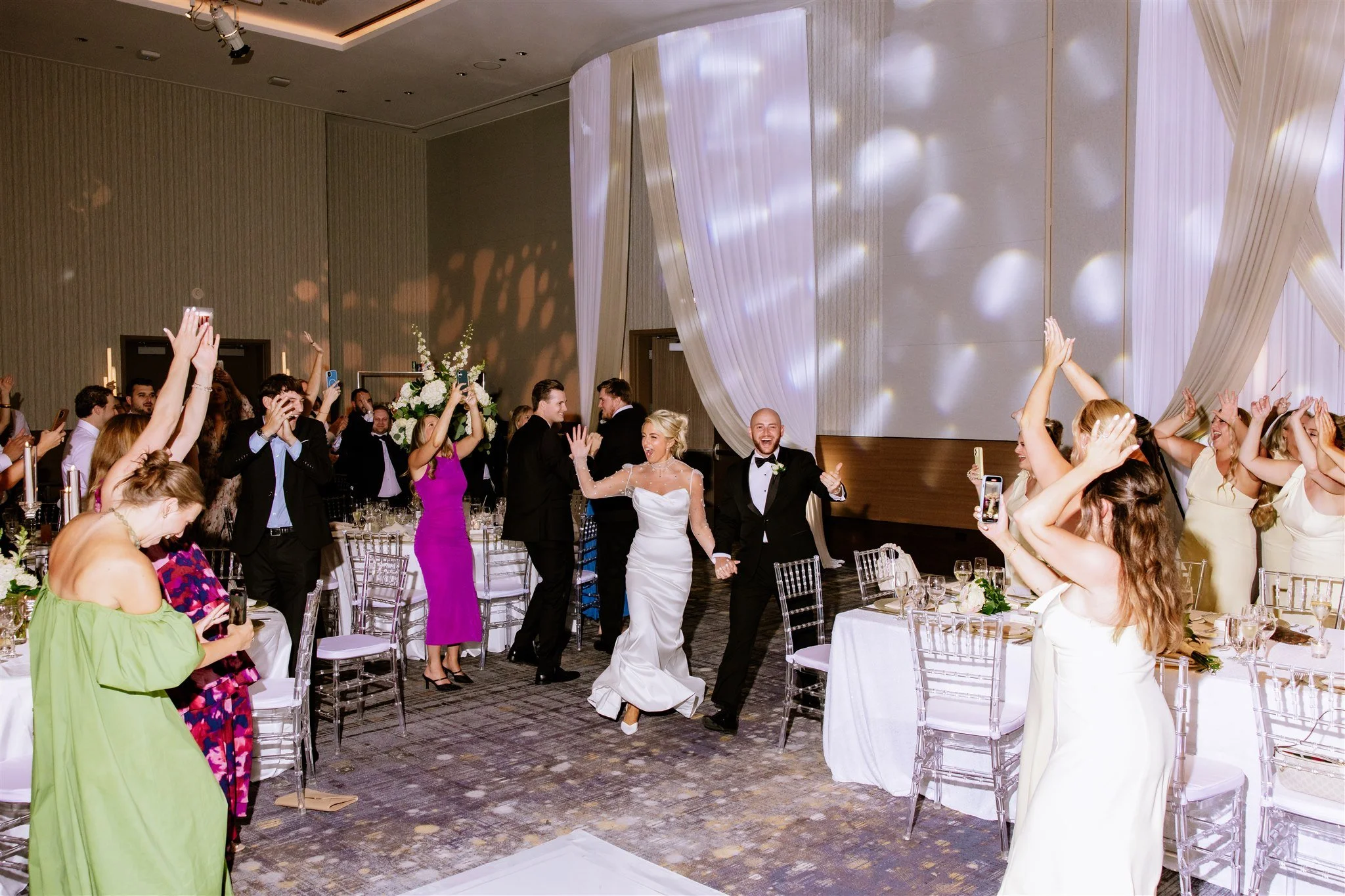 Couple enter Loews Chicago Hotel wedding reception