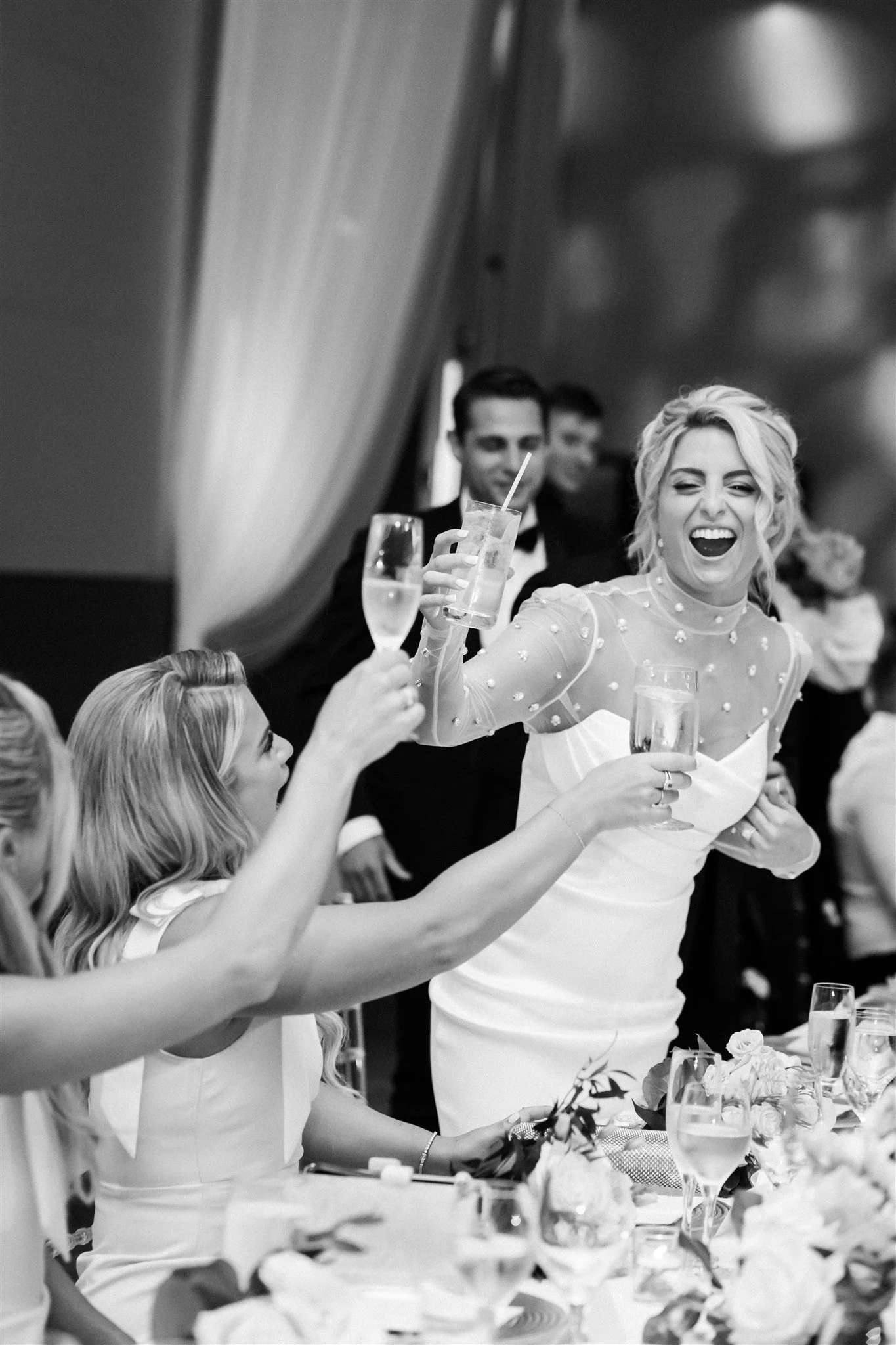 Bride cheers at her Loews Chicago wedding reception