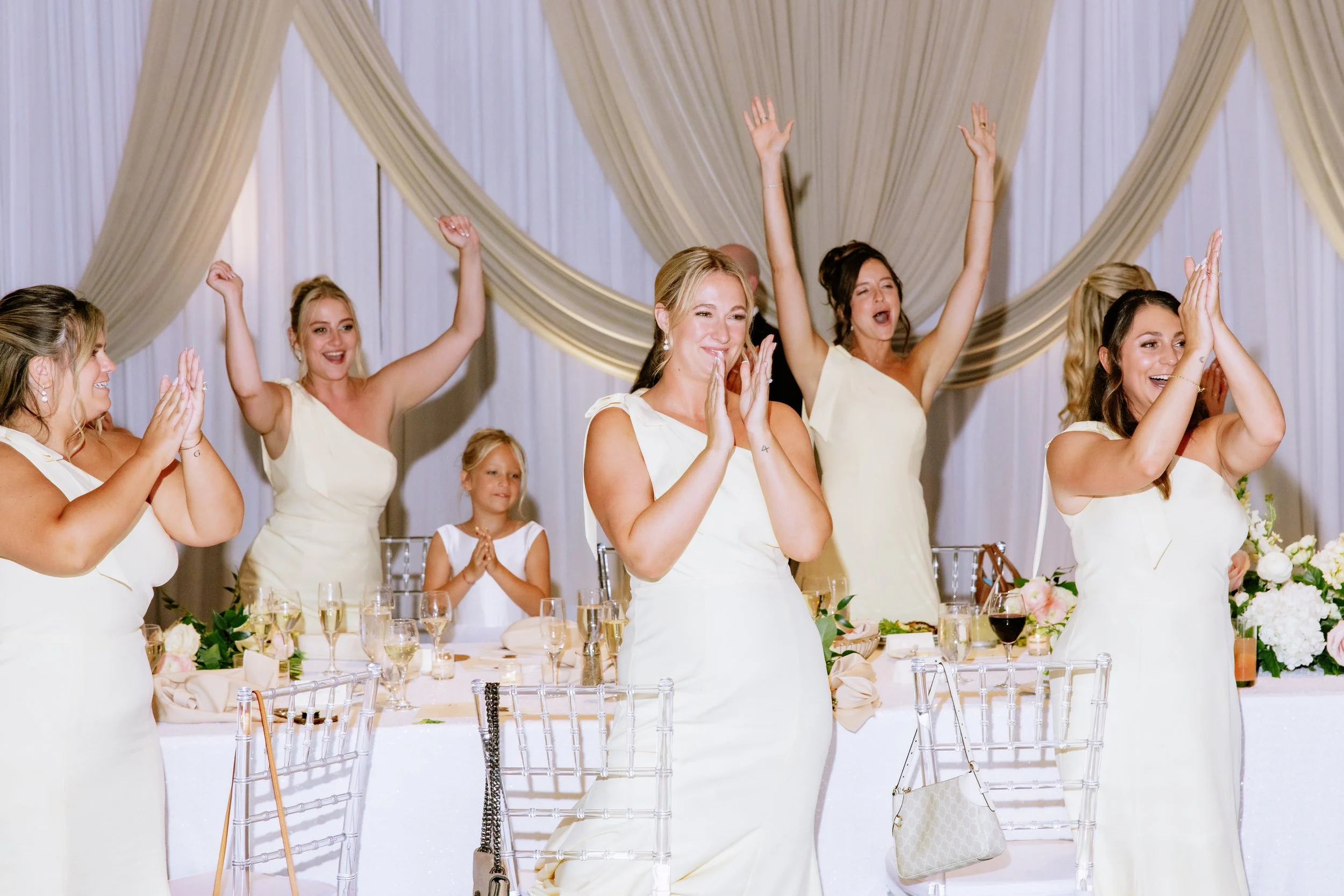 Bridal party claps and cheers at Loews Chicago wedding reception