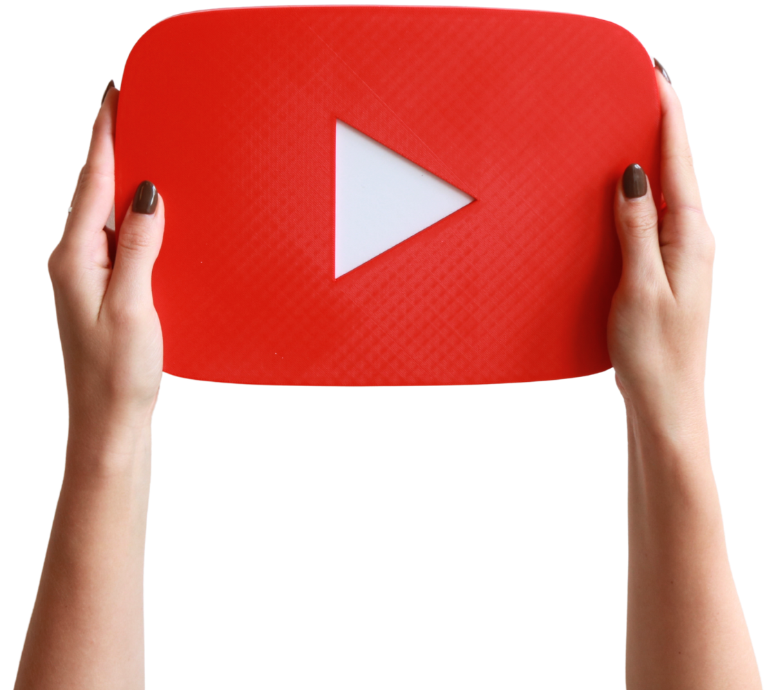 Hands holding a large red rectangular object with a white play button symbol in the center, resembling the YouTube logo.