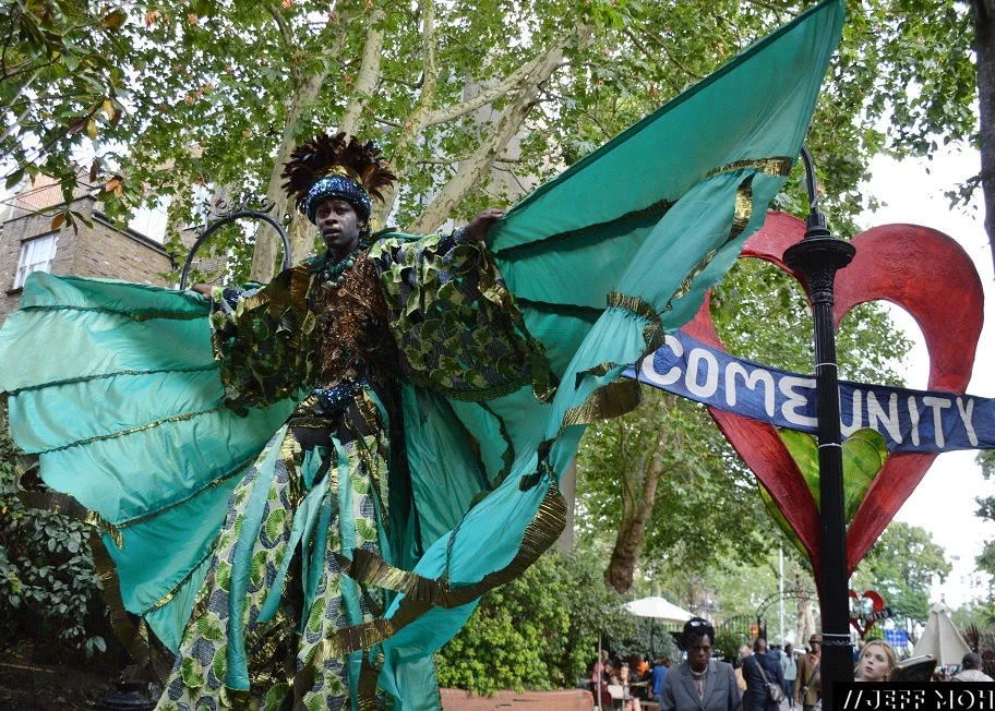 Carnival Stilt Walker promoting the community aspects of Notting Hill Carnival. Photography by: Jeff Moh.