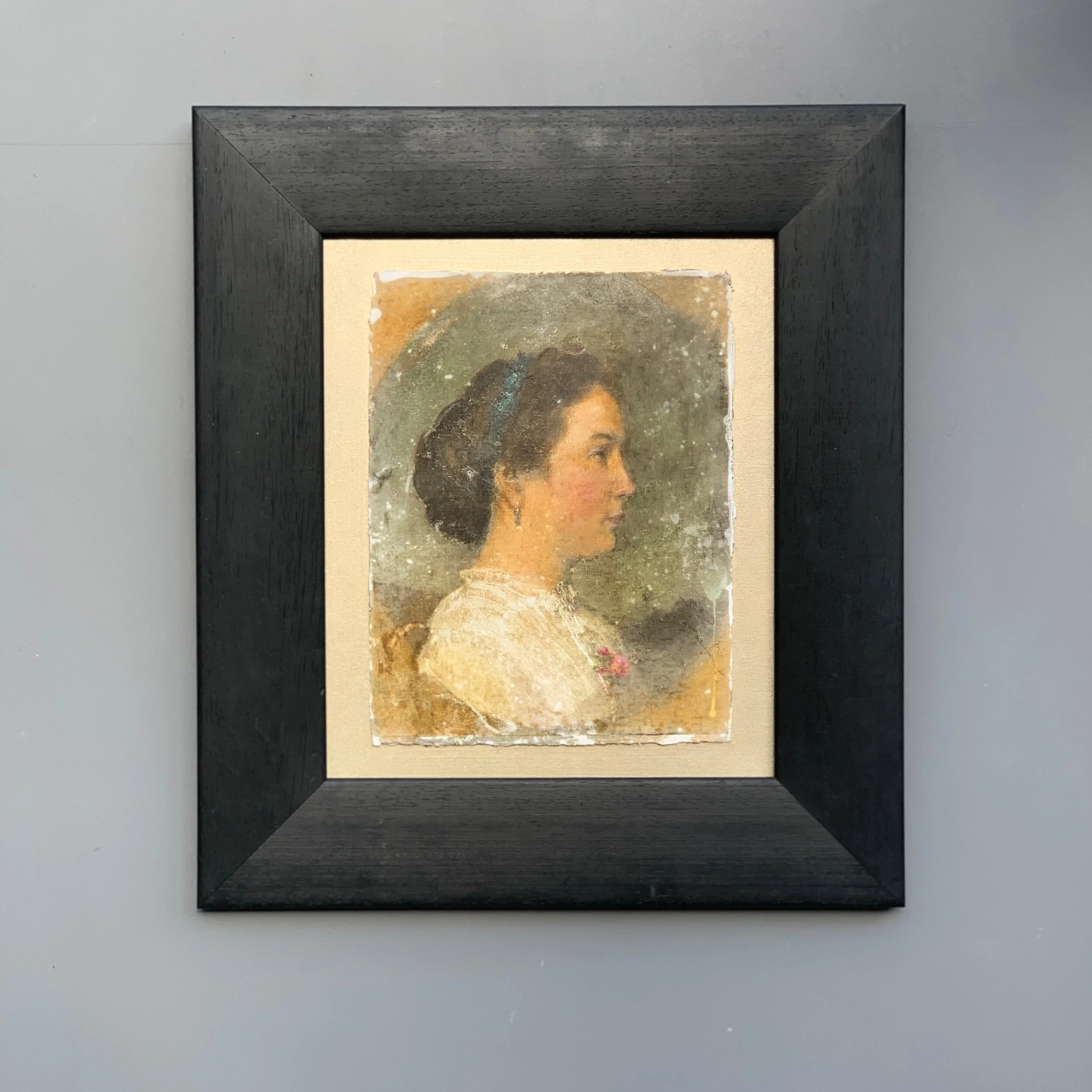Framed portrait on plaster