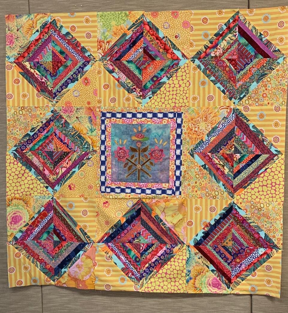  I received the directions for the 5th step and because I did not buy fabric especially for this quilt I knew I would have to improvise a border. I had won a layer cake of Kaffe Fasset citrus hued fabrics. I decided to look in a box labeled “folk Art