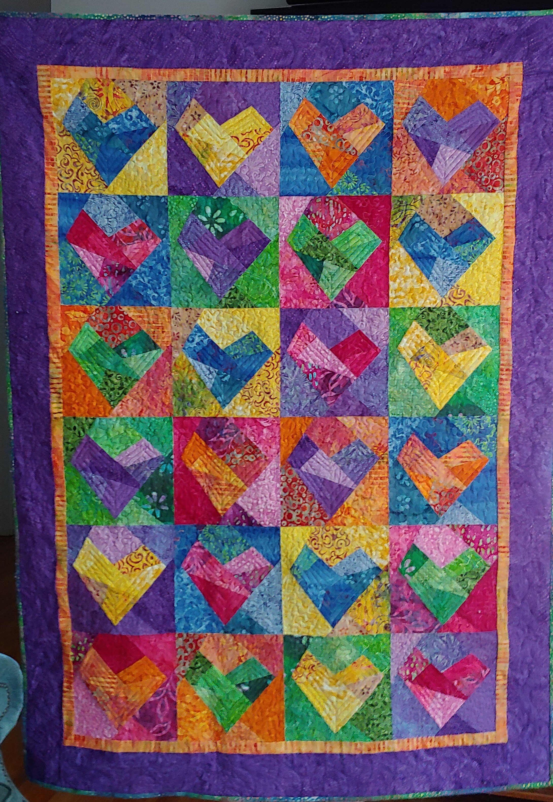  I made the blocks 12 years ago, finished the top 5 years ago, and finally quilted and finished!  Kwik Scrappy Heart by two Kwik Quilters.  Berta K. 