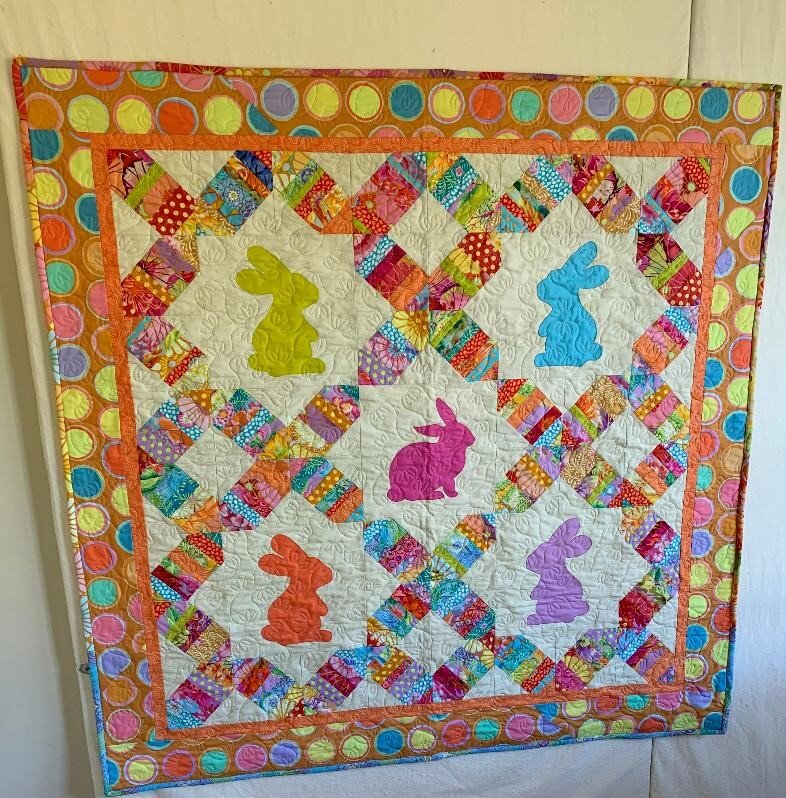  This was made from Kaffe Fassett scraps donated to me by Joan Hartman. It is going into the closet for a future great grand baby. I named it “Some Bunny Loves You” Barbara C. 