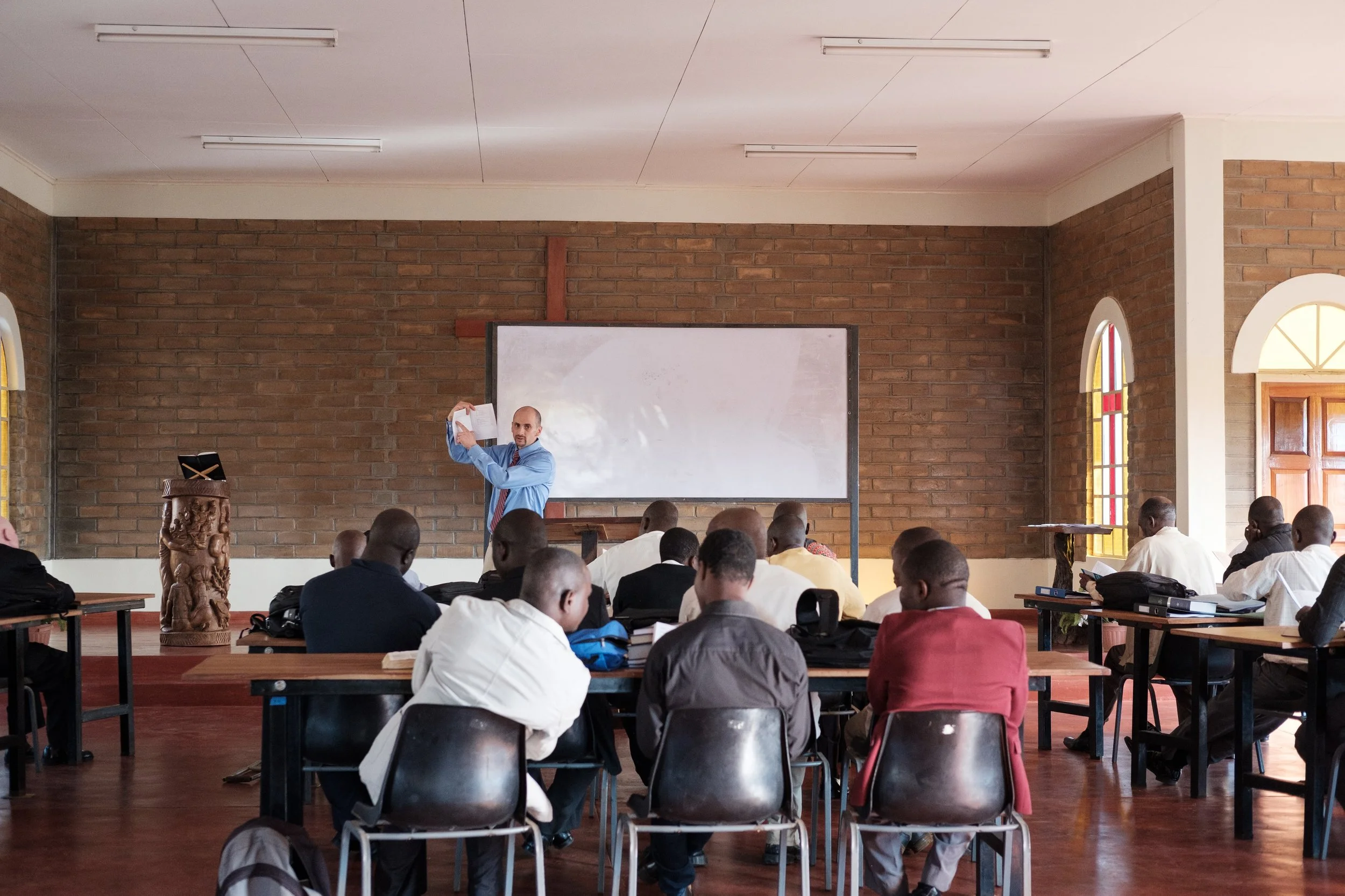 Dave Temple, then the dean of academics, explains the student handbook during orientation on the first day of school.
