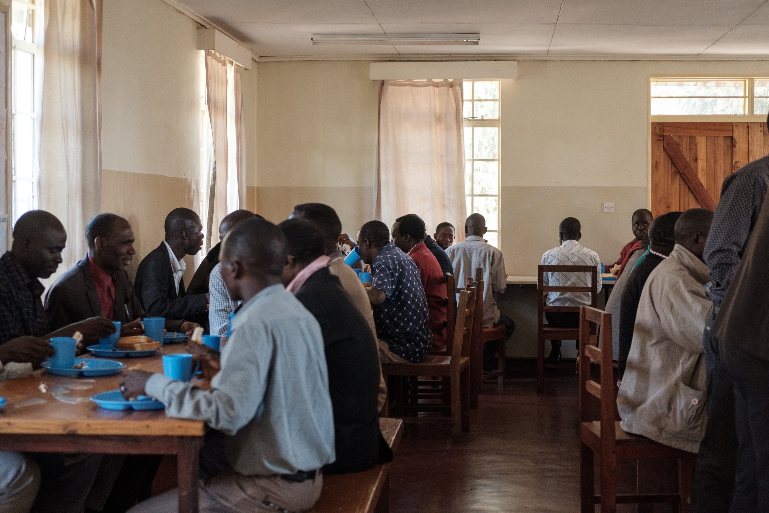 Students eat lunch together in the cafeteria. The meals almost always include nsima, a traditional Malawian cornmeal mash.