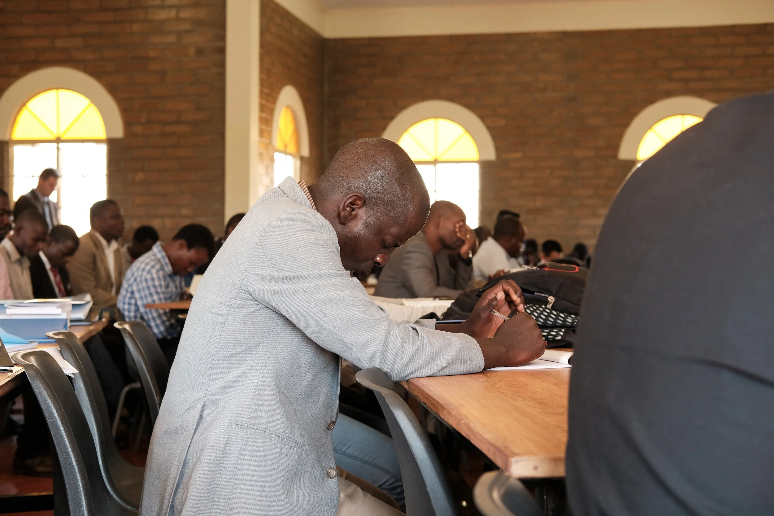 A student bows his head in prayer as chapel concludes.