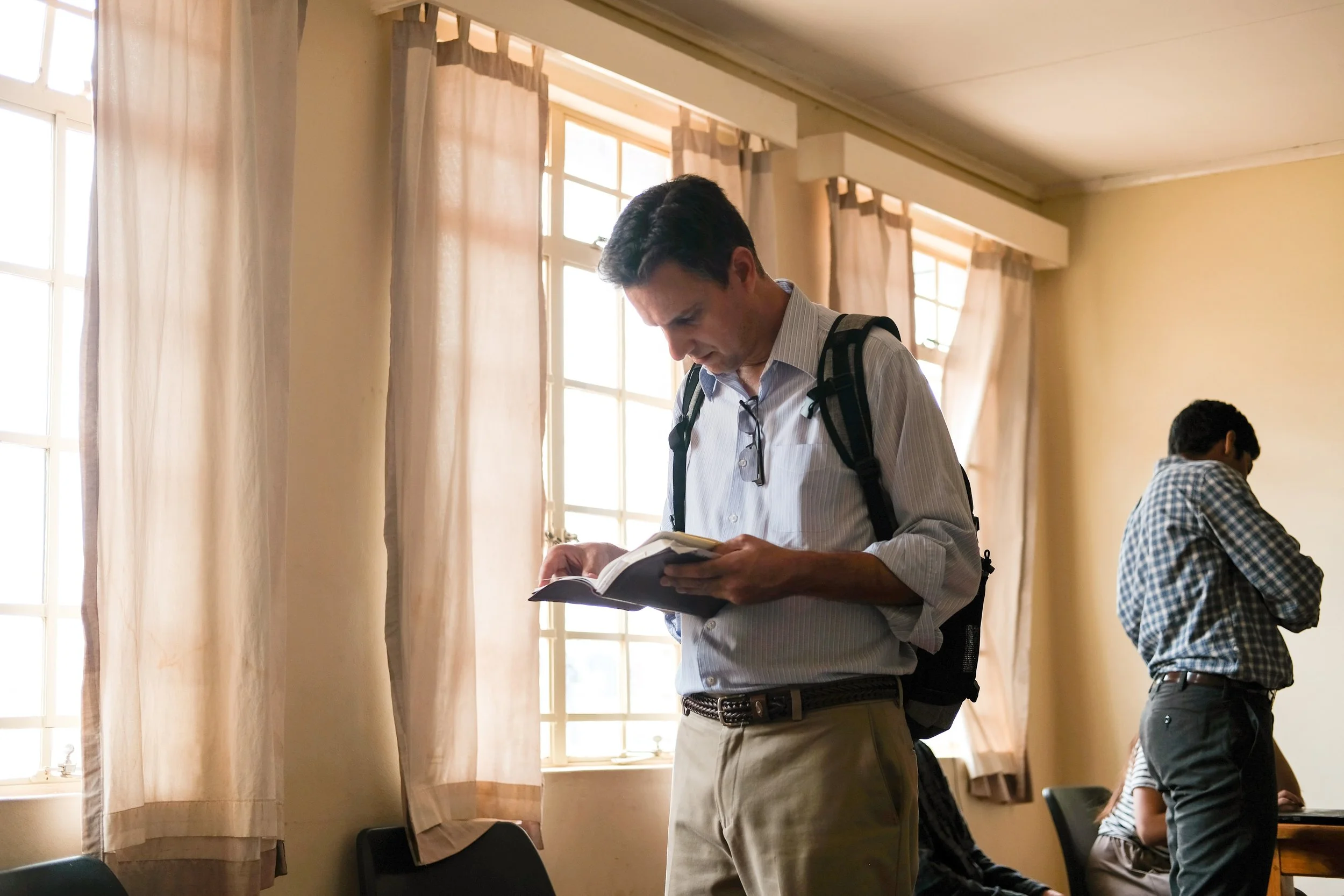 President Jim Ayres flips through a Bible in between classes.