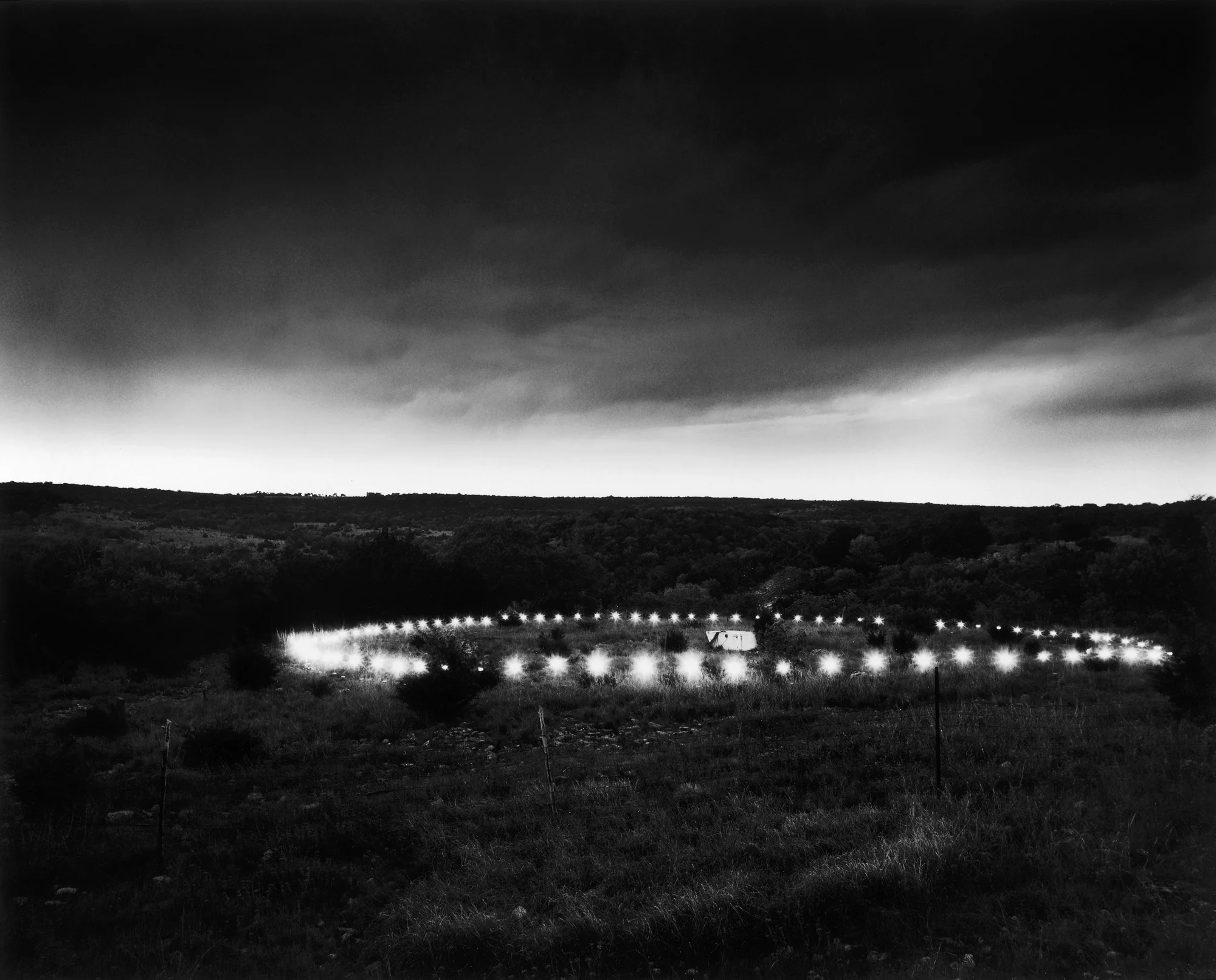 Project Starlight International creates light pattern sequences from a hidden location to attract UFOs flying overhead. North of Austin, Texas 1986.