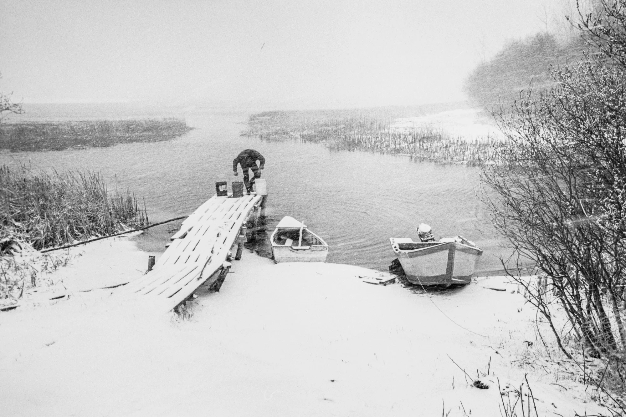 Spring storm, May 1982. Jack Ladouceur drawing drinking water from the shore of Buffalo Lake, Caslan Metis Settlement