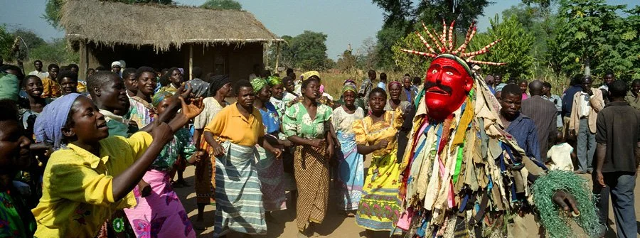 "Kamvulumvulu" / 'the whirlwind' dancing "kumema", a remembrance ritual for a villager.  Gule Wamkulu is performed at funerals,  "coming-of-age" initiation ceremonies and set intervals of mourning rituals.    Luwengwa village, Kachindamoto, Malawi 20