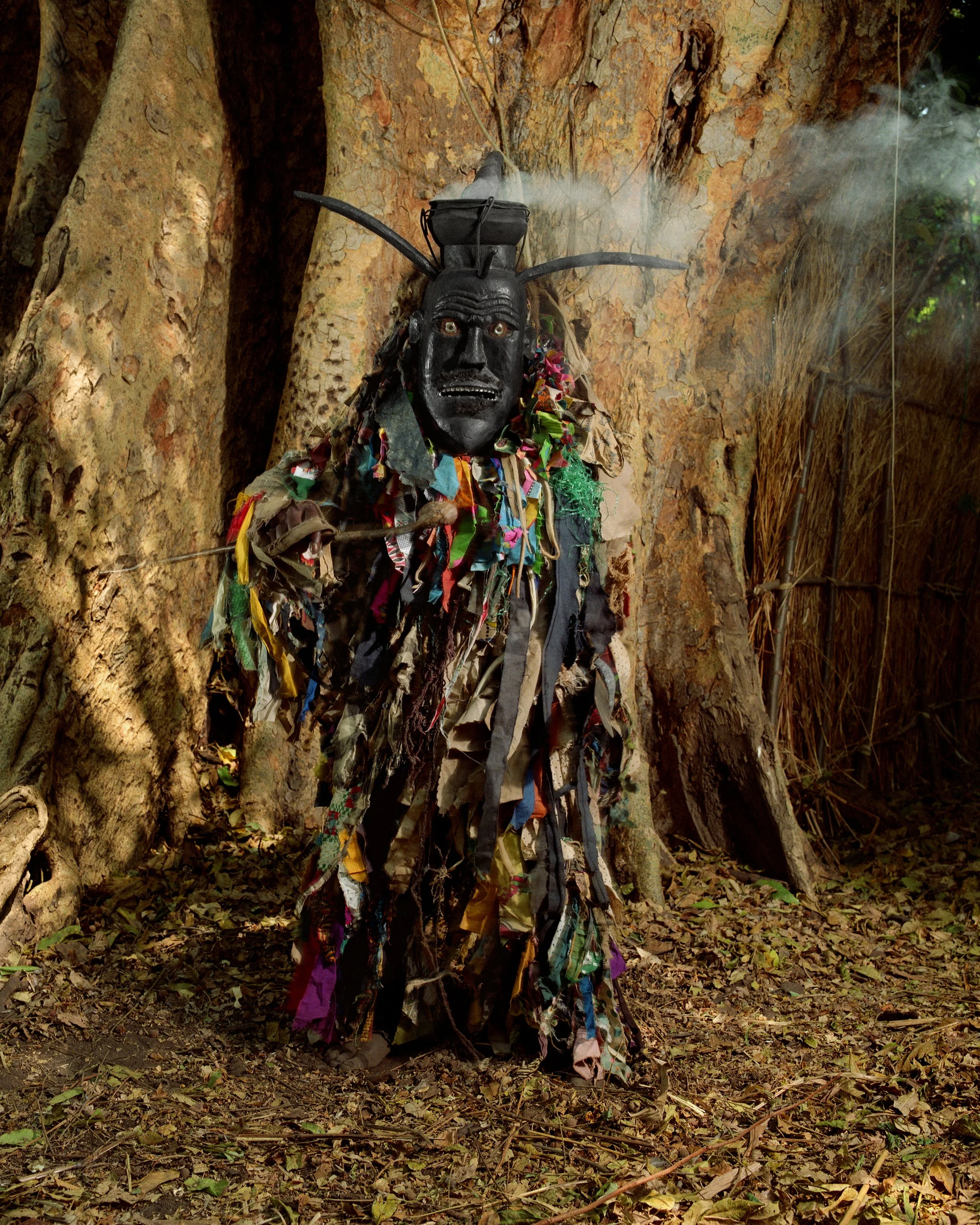 "Mbaula"/ Also know as "Kambulitso" / 'popcorn'. Mbaula's fierce black face symbolizes the deeds of night and the darkness of men's hearts.  He hides evil intentions under the cover of generosity, using tricks and fear to accomplish his aims.  At the