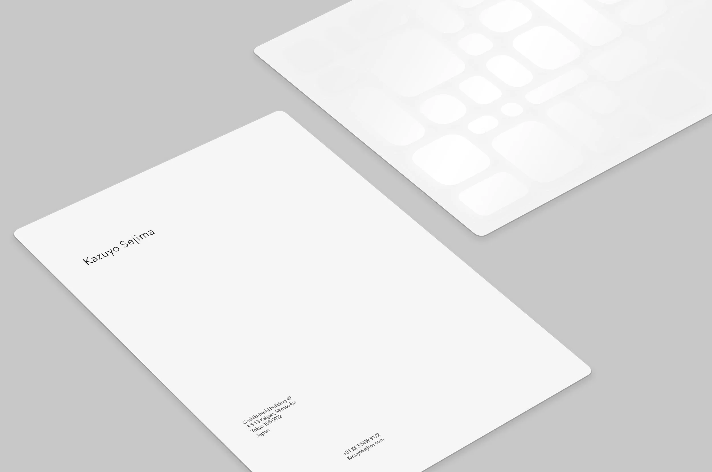  The brand system aims to mimic the relationship Sejima creates between her clean, modernist drawings and the ethereal qualities of the built spaces. A variety of differently sized and shaped rectangles form a grid that informs text placement on the 