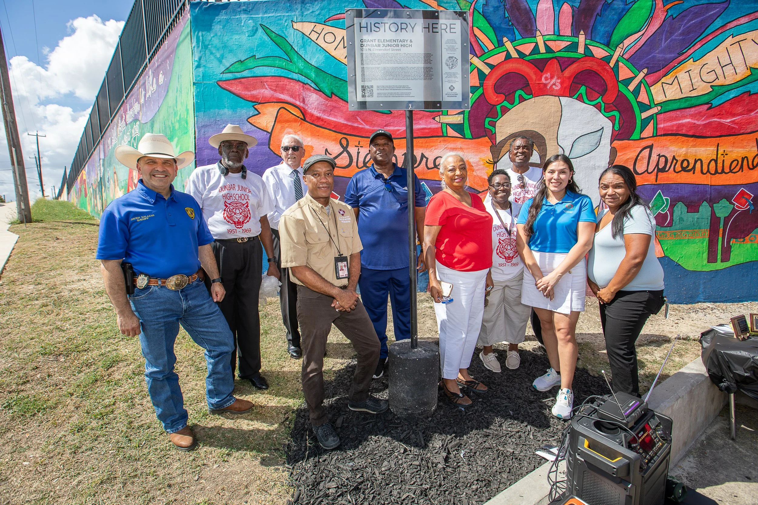 Alumni of  Grant-Dunbar and City officials and staff pose with marker