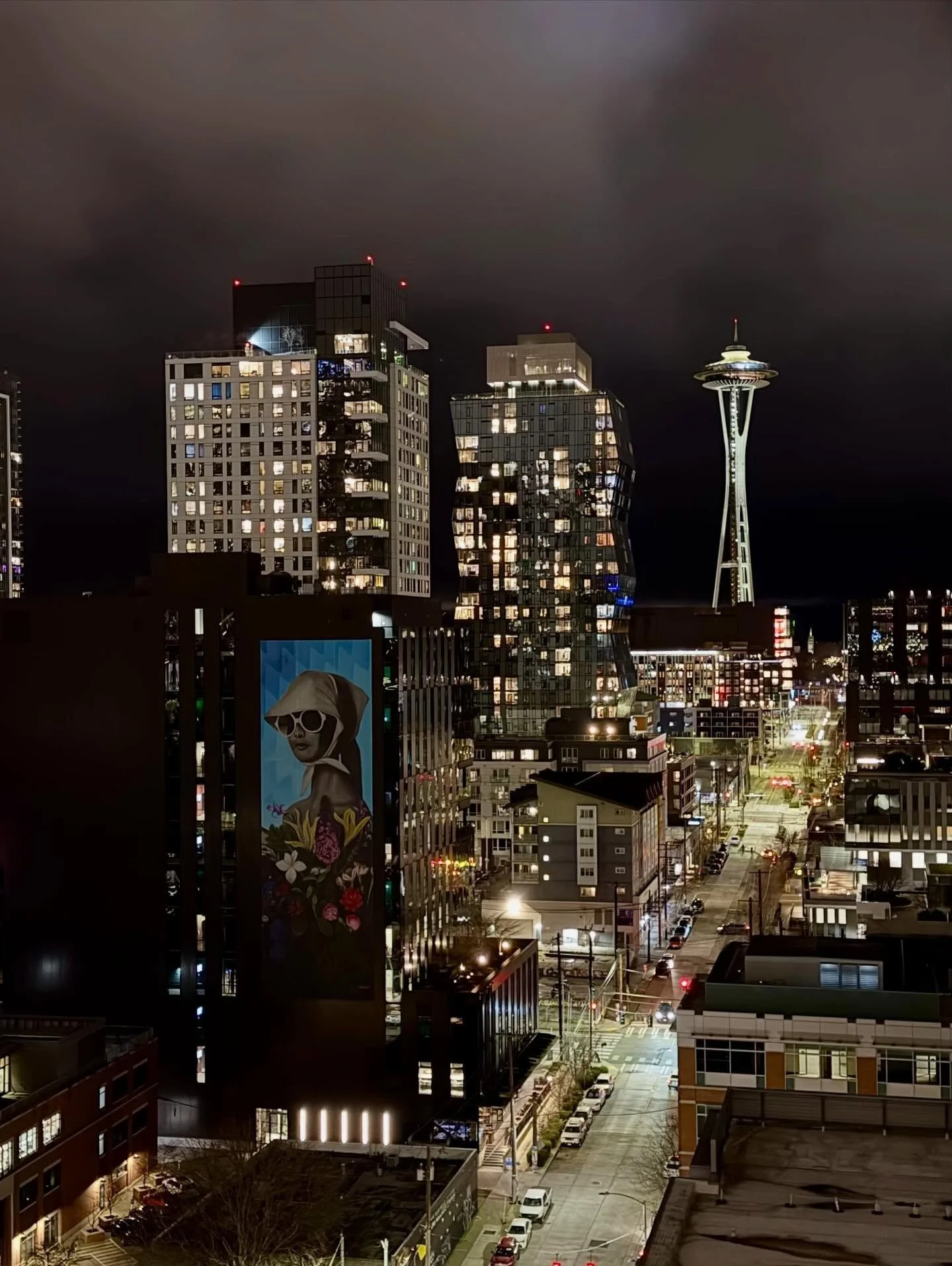 Friday Night Lights ✨9th &amp; Thomas aglow in @southlakeunion, with the @spaceneedle shining bright in the background. Displayed on 9T is &lsquo;Meadow&rsquo; by @justinkaneelder &mdash; bringing color, light, and art to the evening streetscape 🎨

