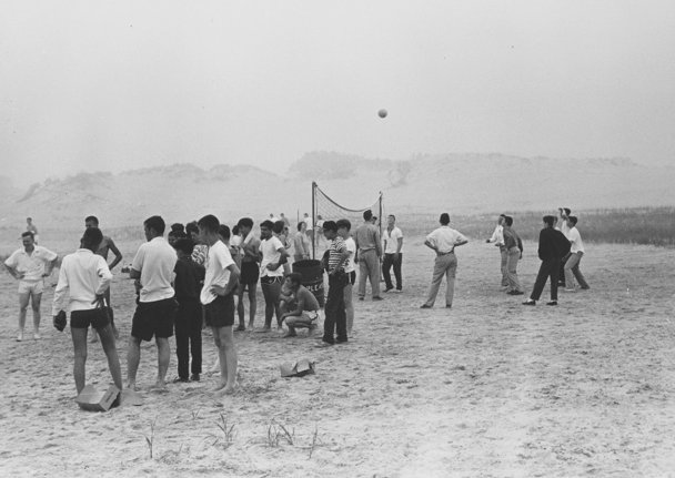 Children playing volleyball on the beach: 1961