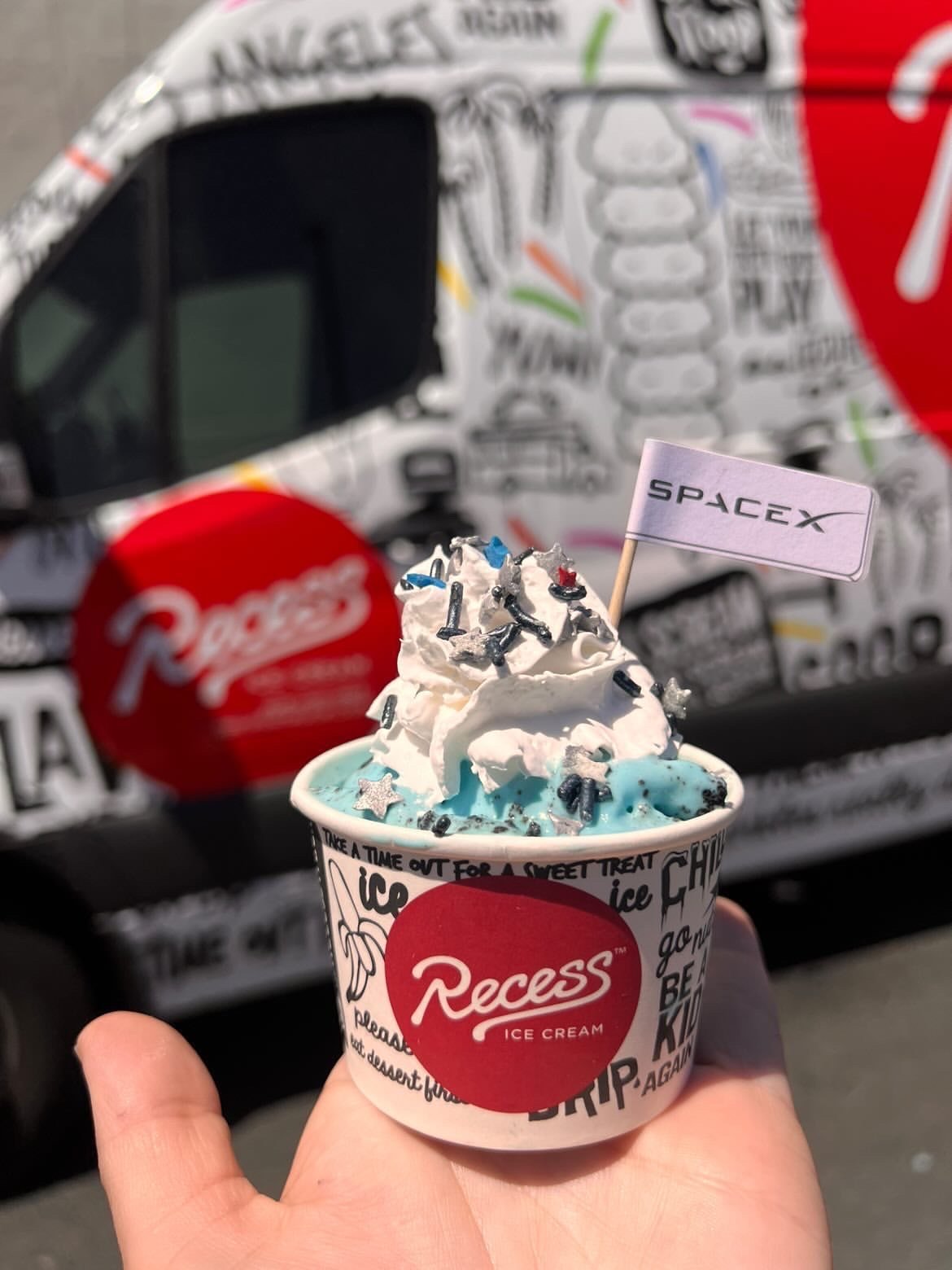 A close up photo shows the SpaceX branded Recess sweet treats