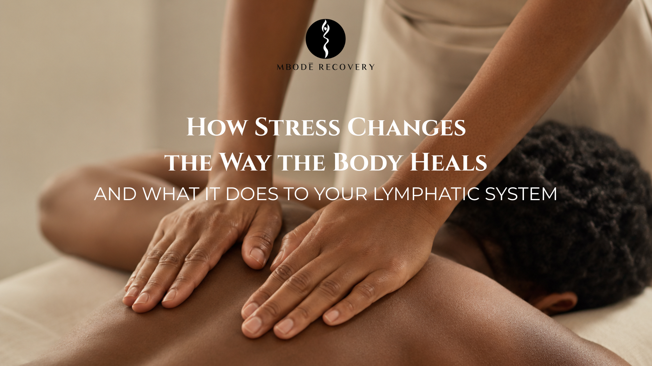 Practitioner's hands resting gently on a client's upper back during a lymphatic drainage massage session at MBODE Recovery, Atlanta