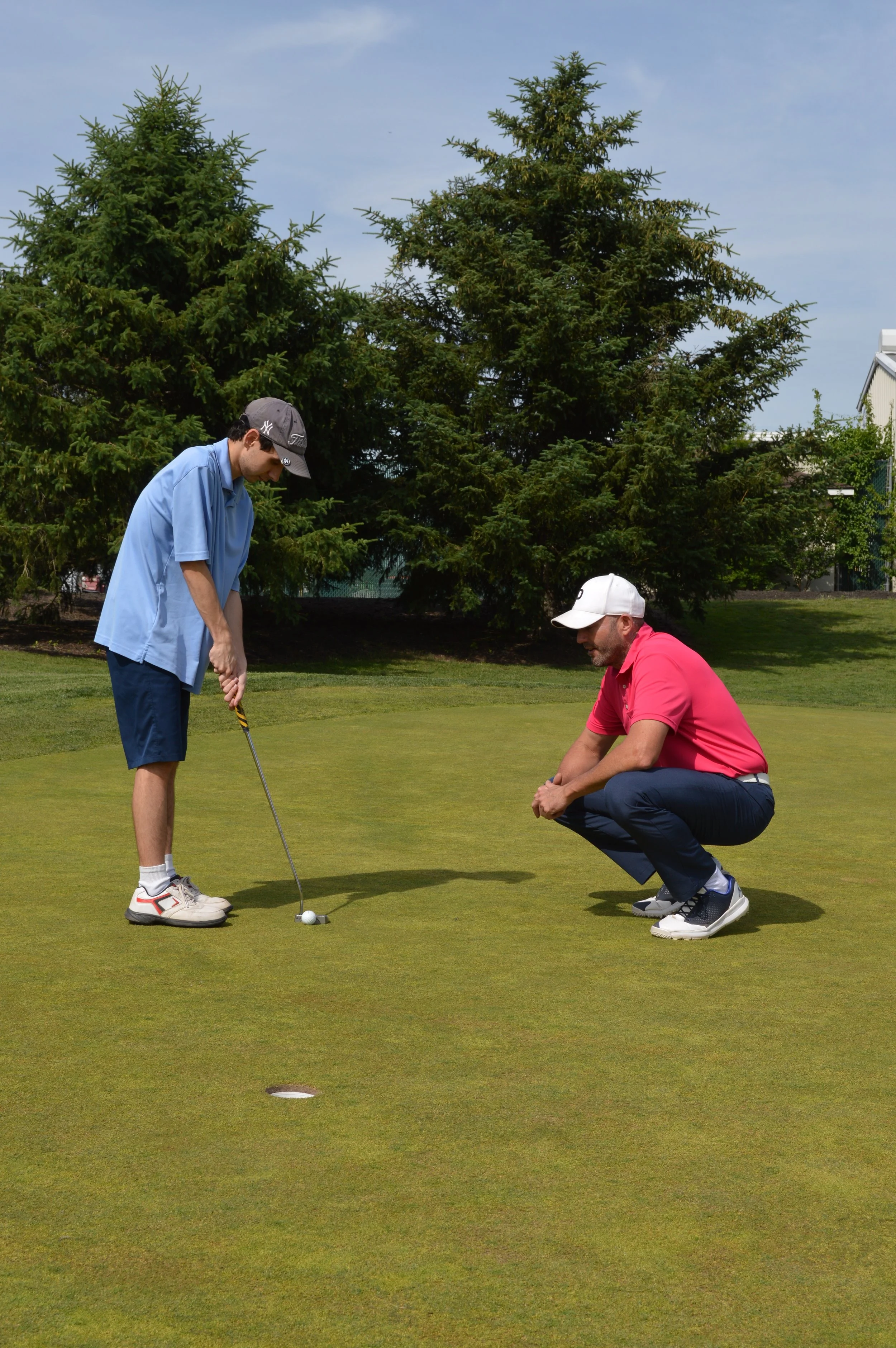 Arthur practicing his putting with his coach, Dustin Stearns