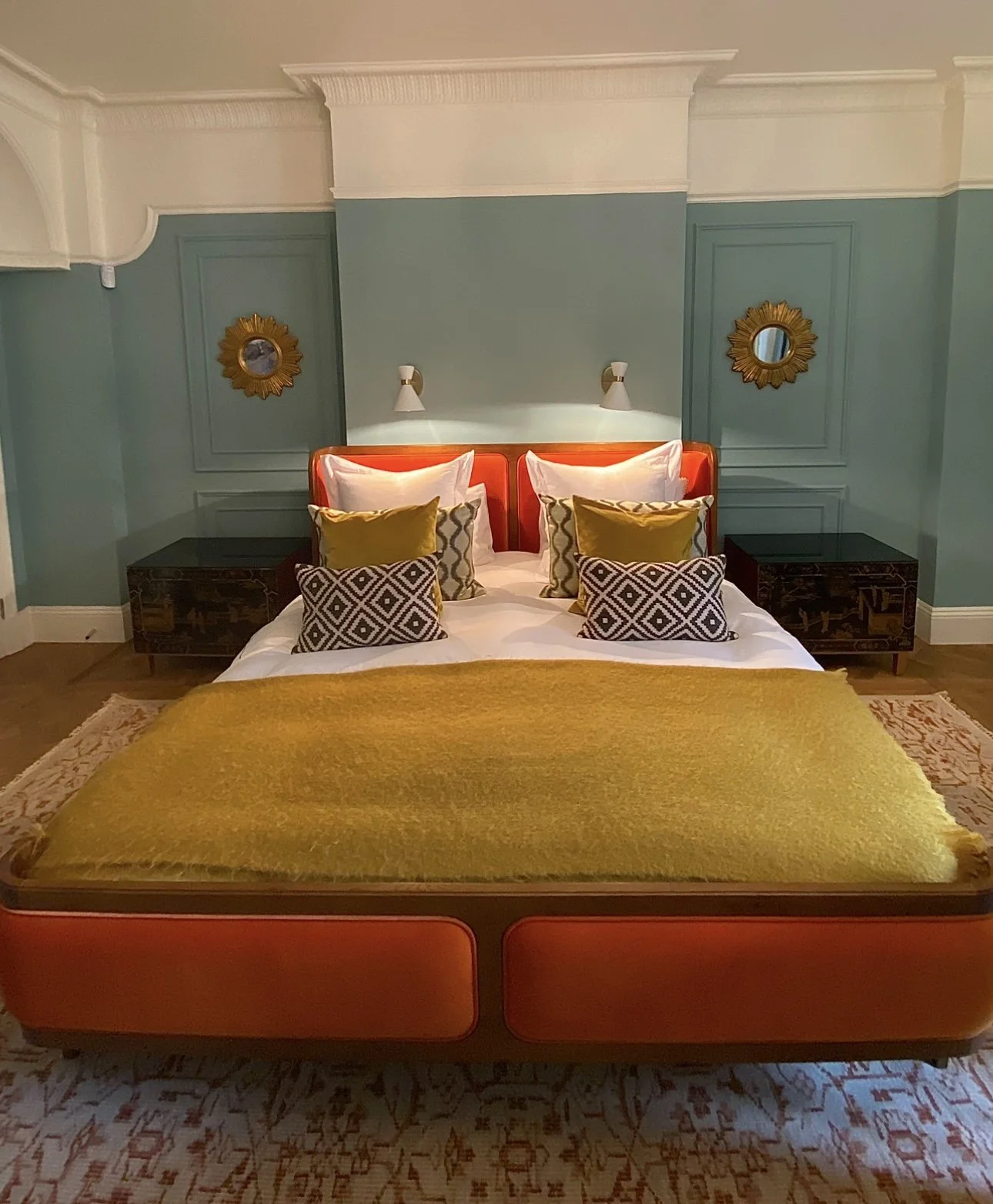 A bedroom with a mixture of modern and antique furniture.