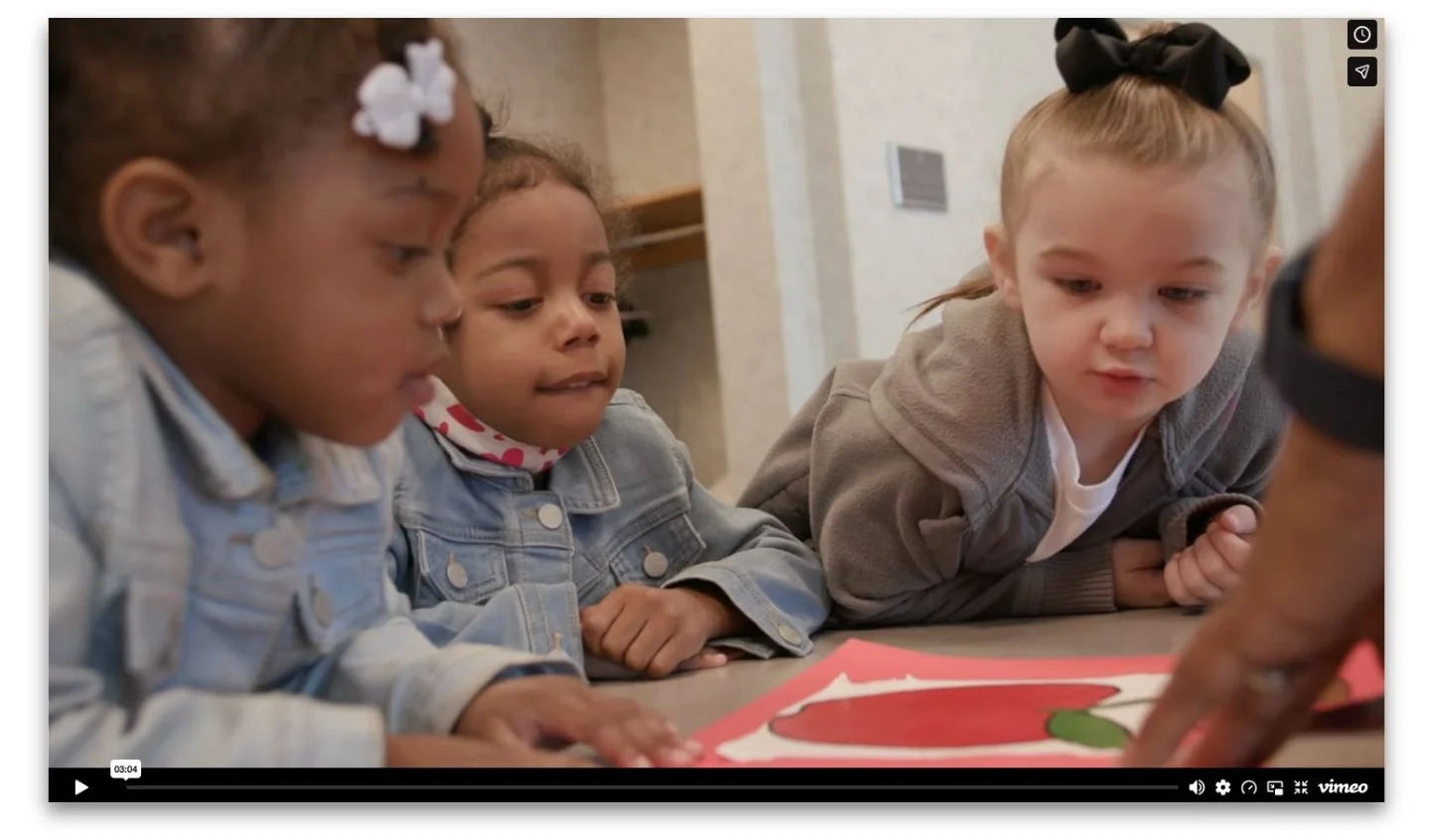 Three diverse preschool-age children focused on a picture book, from a video highlighting The Innovation Project's early childhood education partnership with Edgecombe County Public Schools.