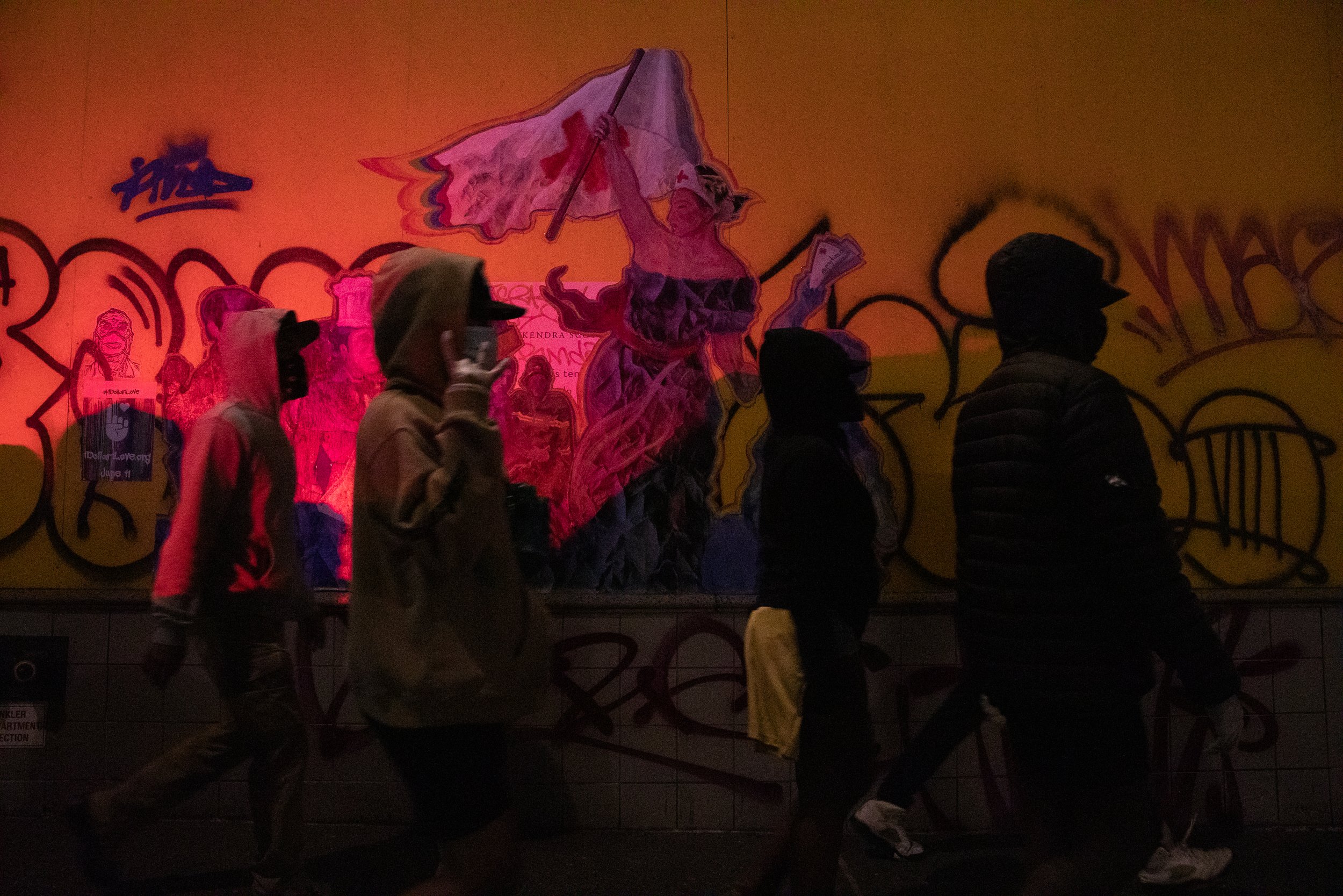  During a night of civil unrest following the murder of George Floyd, people walk past a rendering of Eugène Delacroix's Liberty Leading the People. New York City, 1 June 2020 