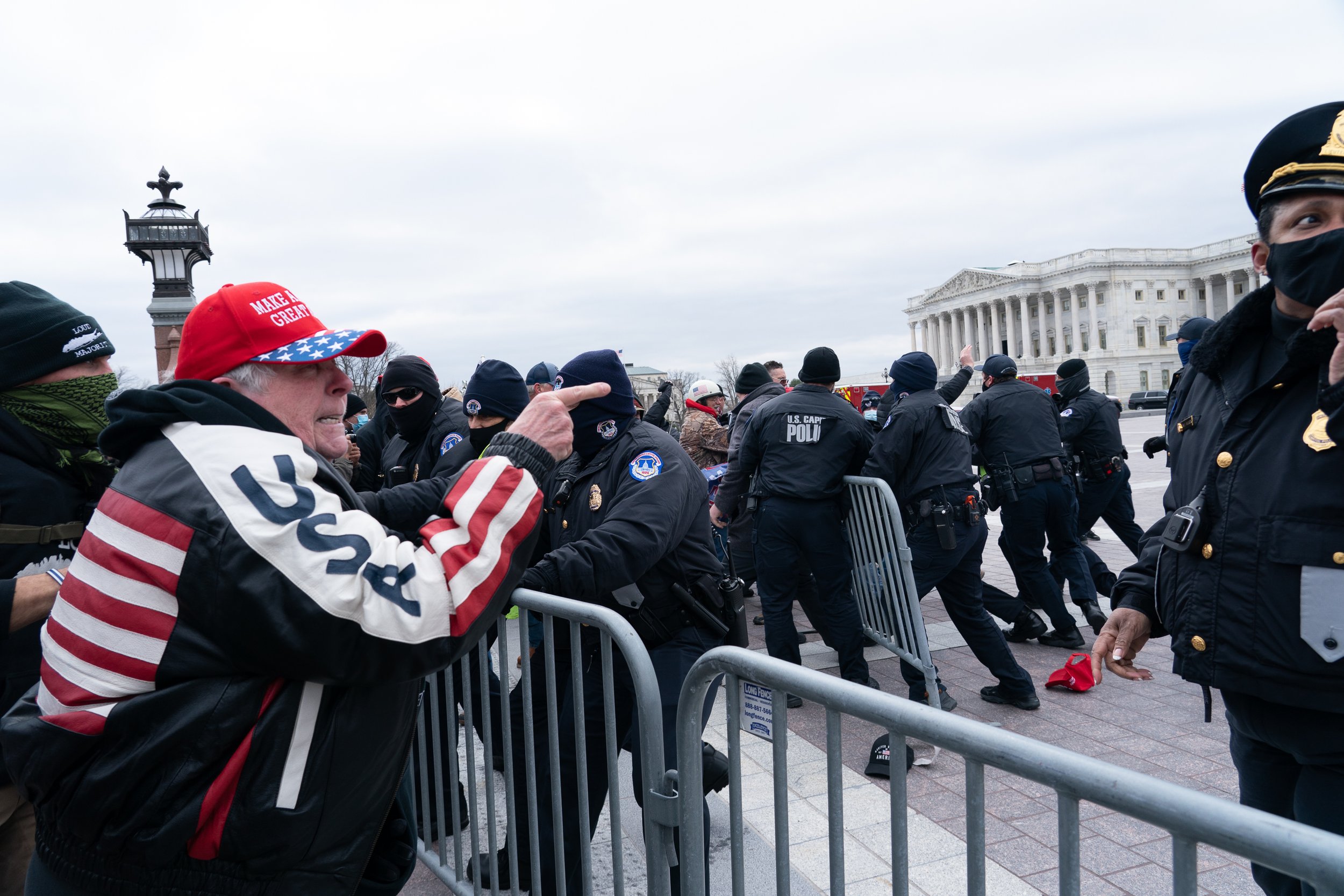  Trump supporters breach police barricades and storm the U.S. Capitol during a joint session of Congress to prevent electoral votes from being counted. Washington, D.C., 6 January 2021 