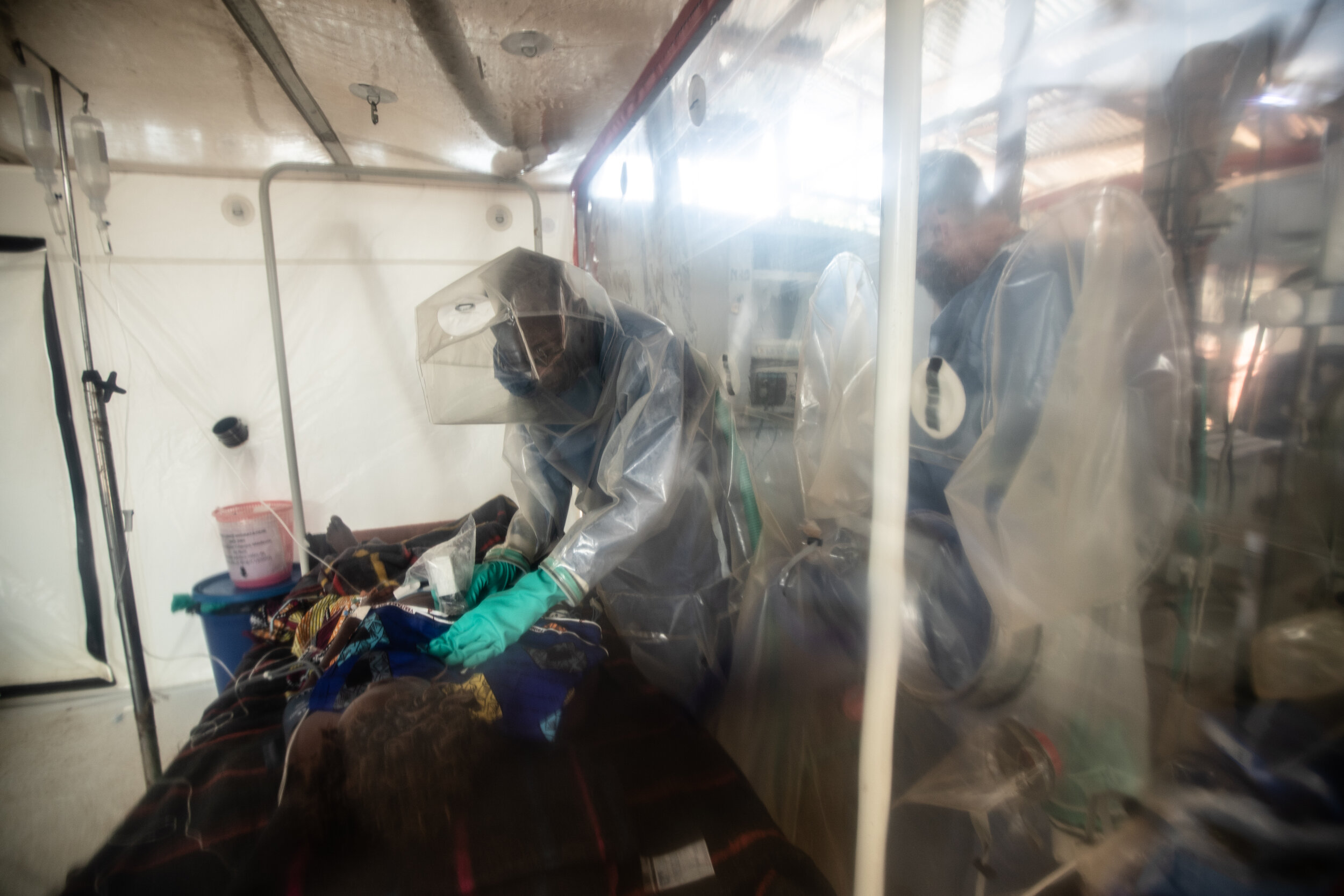  Dr. Richard Kojan, an intensive-care specialist and director of ALIMA NGO, performing a sonogram on a 53-year-old Ebola patient.  the significant contribution to improving the care for Ebola patients was brought by ALIMA through the innovation of th