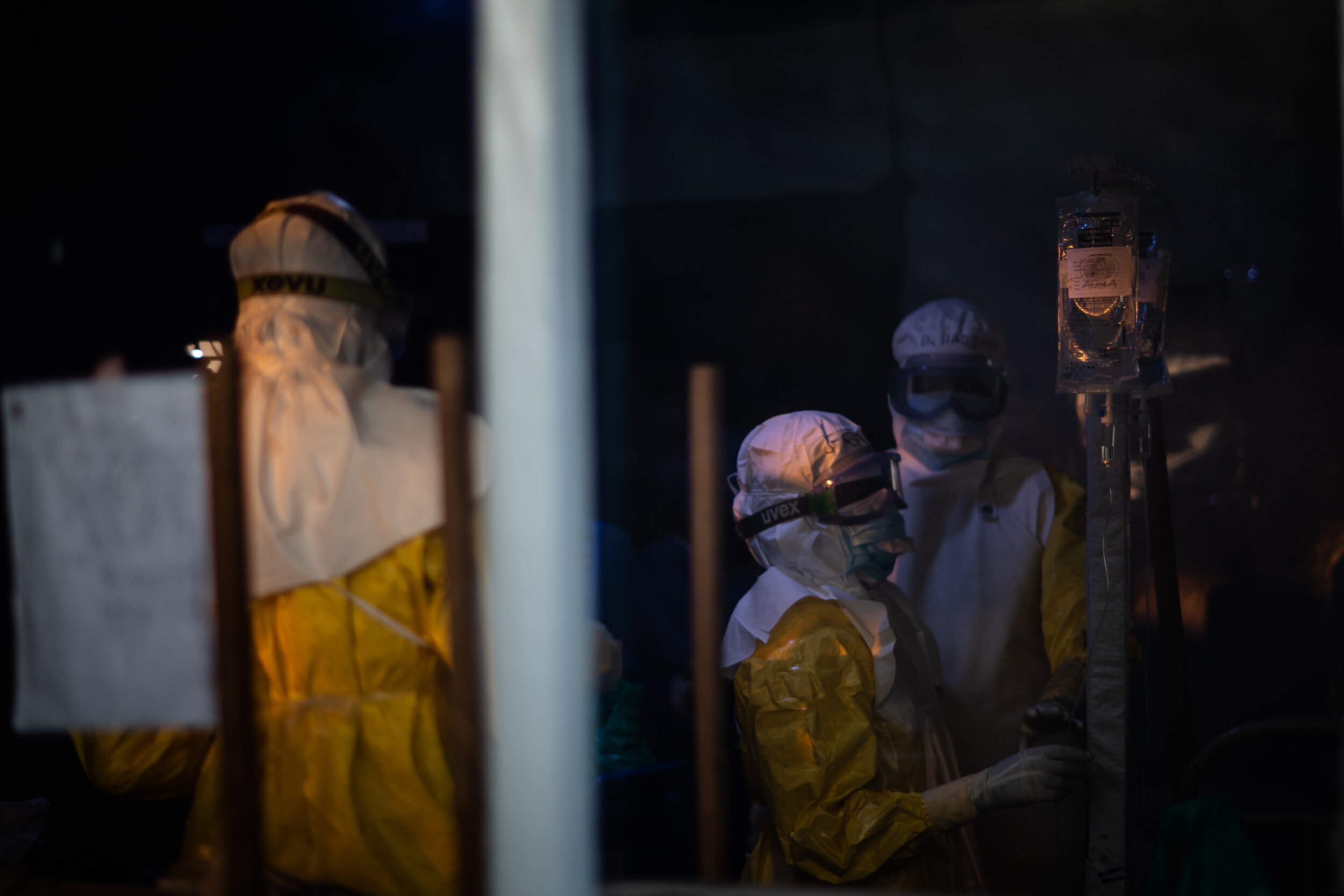  medics checking on patients at sunset, at Beni Ebola treatment center, The Democratic Republic of Congo, 2019 