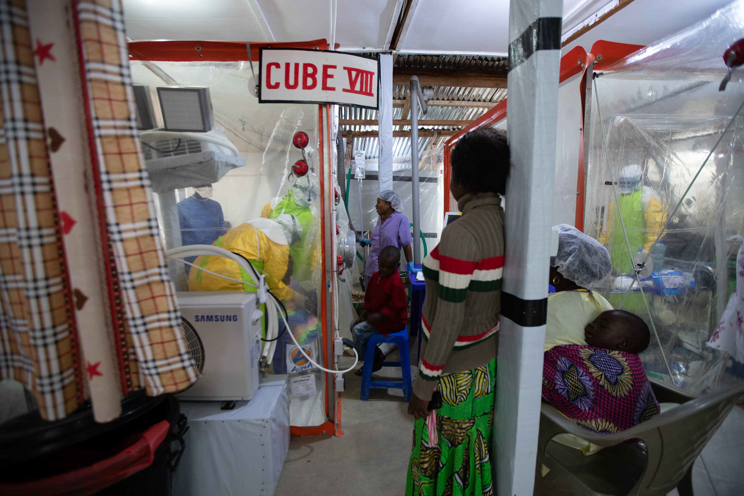  a family visit to Silvie, a 10 years old Ebola patient who lost her mother to Ebola and had been in the CUBE “the Biosecure Emergency Care Units for Epidemics” receiving her treatment. Katwa, DRC, 2019  