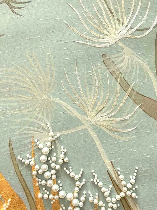  Luxurious close-up of hand-painted silk wallpaper showing a coral reef and scattered pearls, a premium option for designer wallpaper in upscale interiors. 