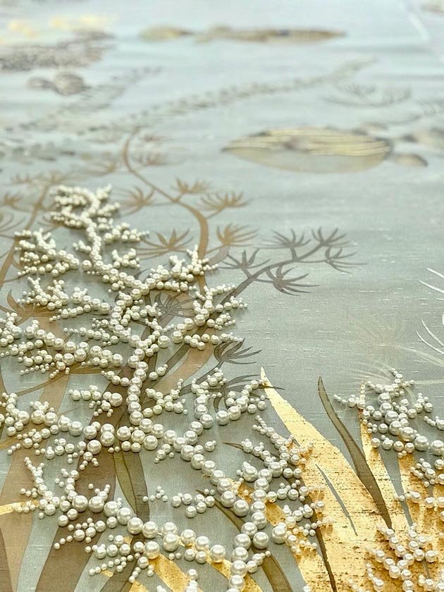  Close-up of luxury hand-painted silk wallpaper depicting a vibrant coral reef scene with colorful fish, seaweed, and pearls, crafted for high-end interior design. 