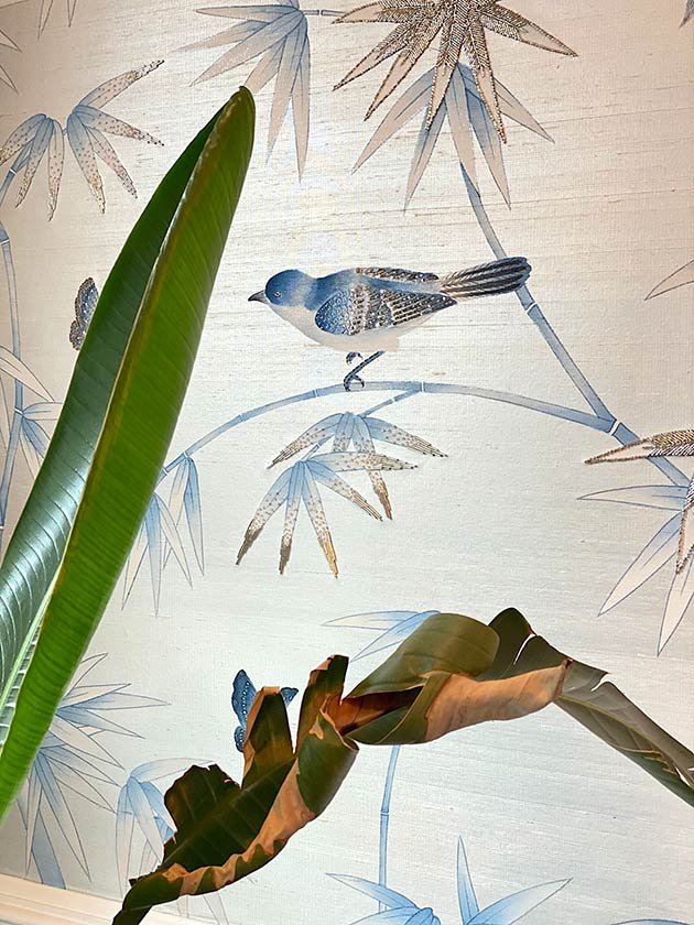  Hand-painted Chinoiserie wallpaper with a vibrant blue bird sitting on a bamboo branch, a stunning example of luxury wallpaper for exclusive interiors. 