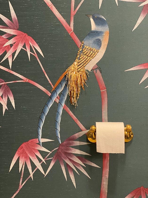  Luxury wallpaper with a hand-painted blue bird with a gold feather perched on a tree branch in a bamboo jungle, a unique piece for exquisite interiors. 