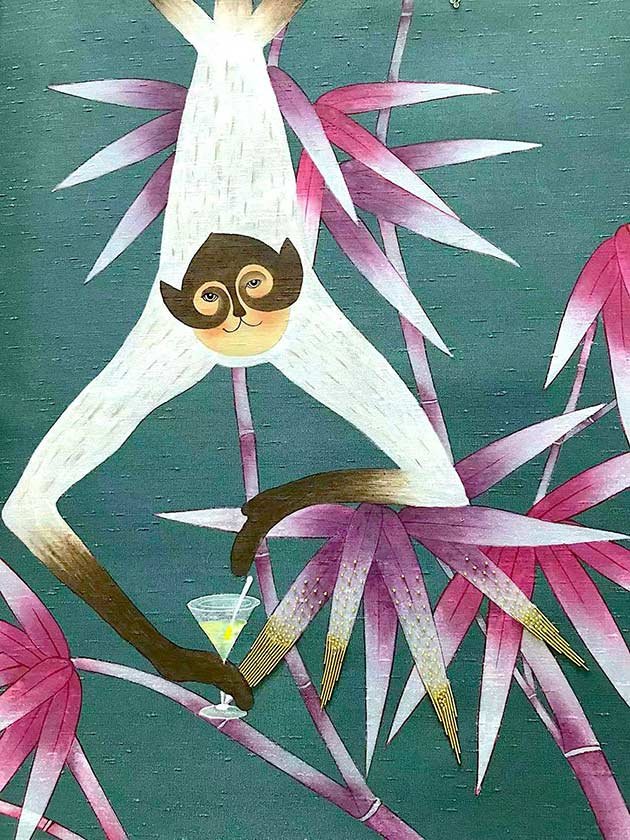  Whimsical hand-painted bamboo jungle wallpaper with a monkey holding a margarita glass, a luxurious touch for designer living spaces. 