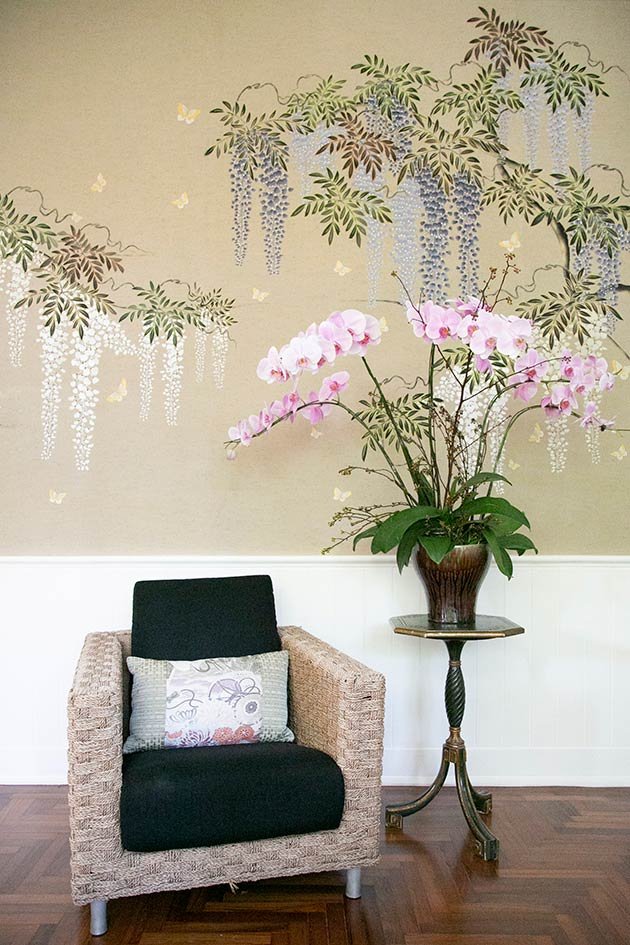  Elegant interior scene with an upscale chair and table against Wisteria Palace Embroidered Wallpaper on Thai silk, highlighting luxury design elements. 