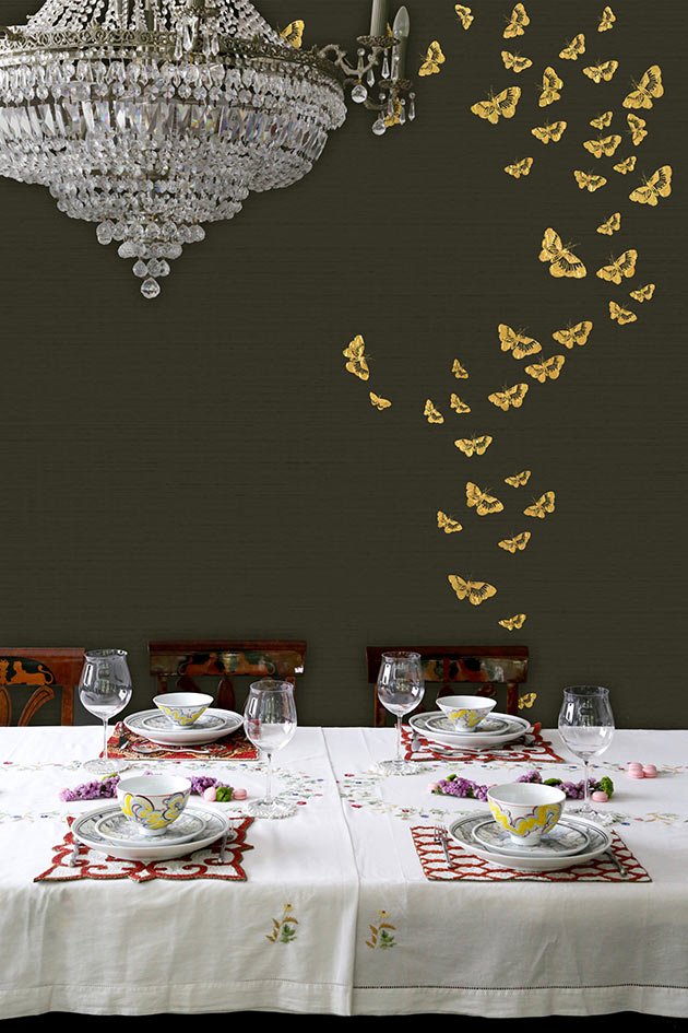  Luxurious dining room decor with a gold and glass chandelier and Butterflies Retreat hand-painted iridium-colored wallpaper adorned with graceful butterflies. 