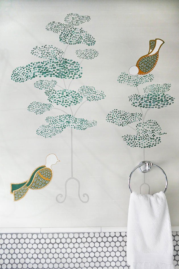  Elegant bathroom design highlighted by a Cloud Tree hand-painted mural with green, white, and orange birds, creating a tranquil and captivating environment. 