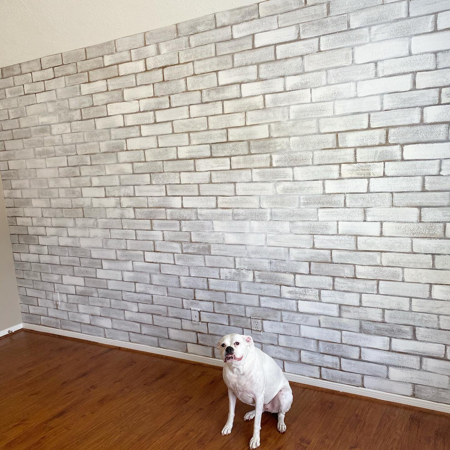 Faux white washed brick wall is finished and Zoey approves! #fauxbrick #brickwall #nursery #nurserydecor #localartist #mural #accentwall #interiordesign