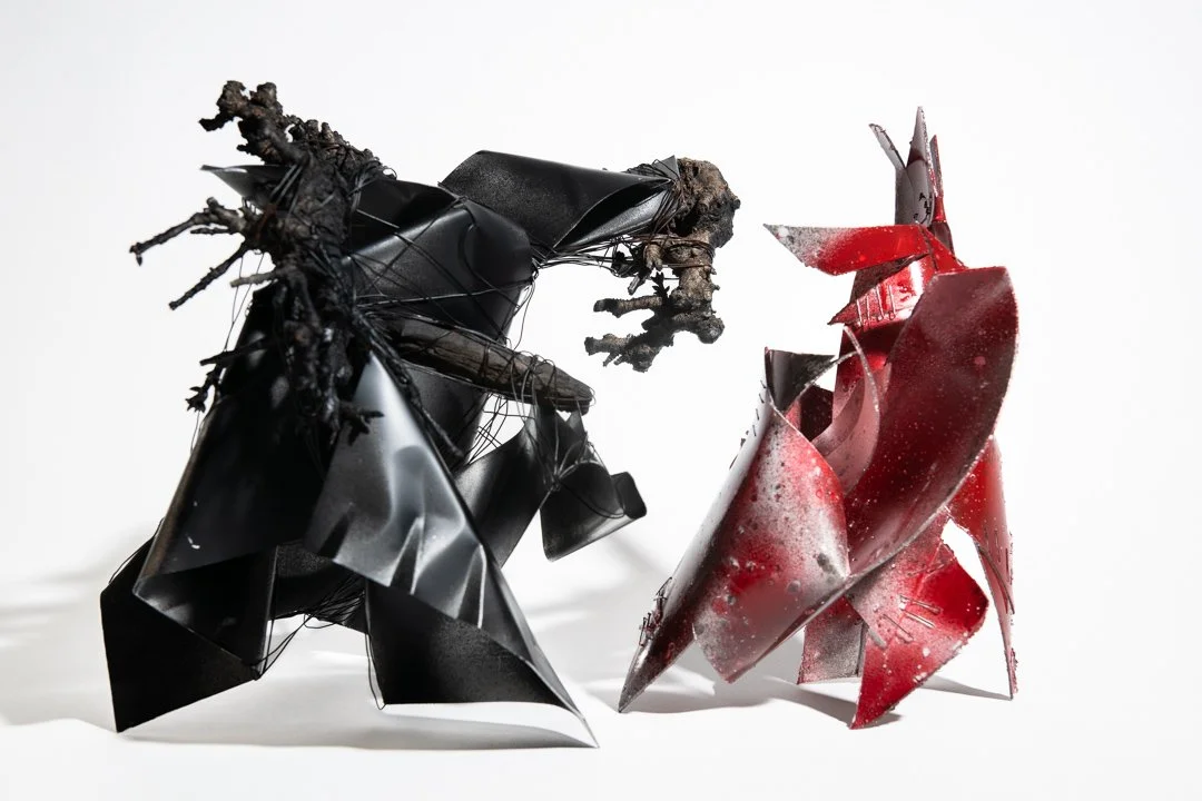 Black and Red Warriors, abstract sculpture with dynamic shapes exploring the power of play in form, made from aluminum, wire, cherry tree prunings, repurposed plastic, and steel staples.