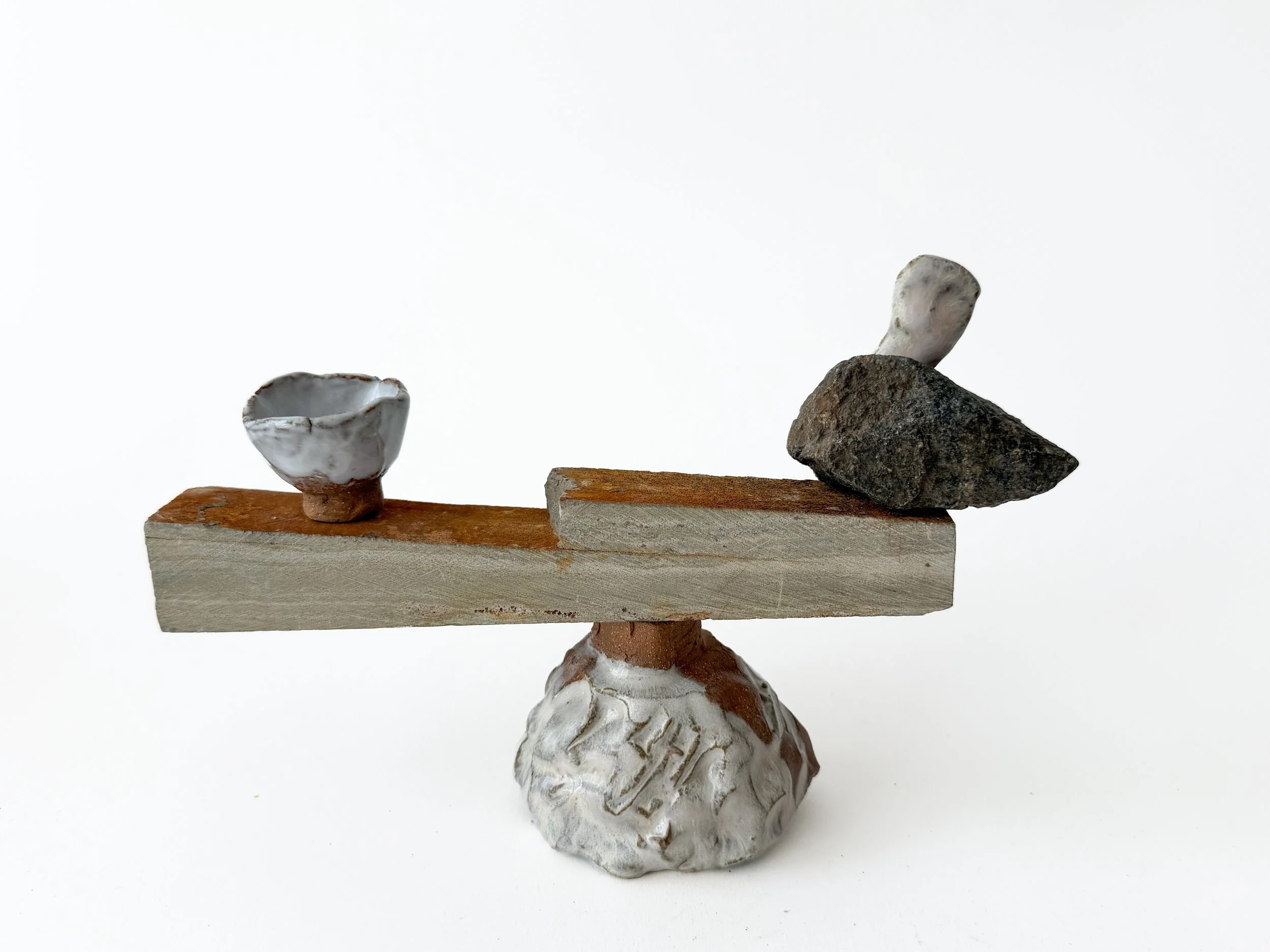 assemblage from hand made ceramic and stone, commentary on life's precarious balance