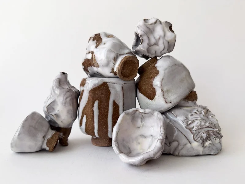 Abstract red stoneware and white-glazed ceramic vessel construction by Donnelly Marks, transforming familiar vessels into surprisingly new compositions.