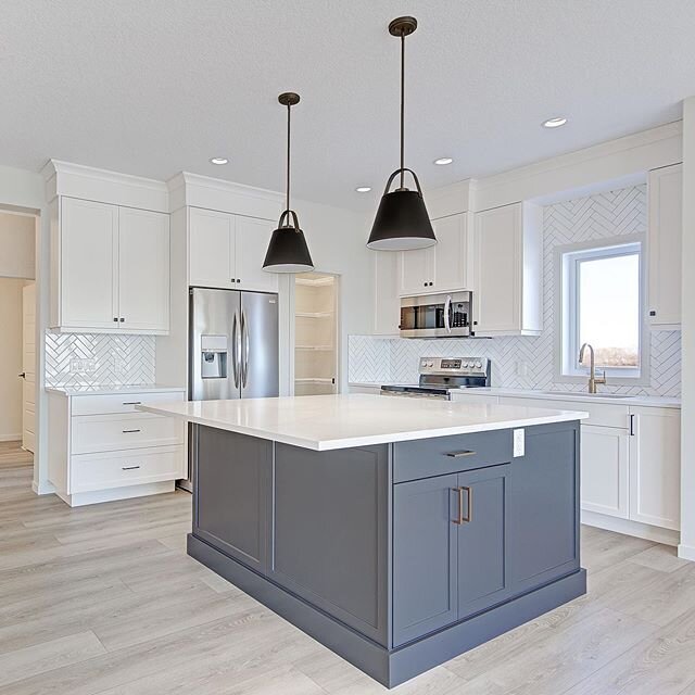 Stunning white on white kitchen with gold faucet and dark grey accents in our brand new model, the Avant. 
Photo by @LADumontphotography
Cabinets by @westsidefinishingltd
Countertops by @bordtstoneandtile
Tile &amp; Flooring by @mintfloorcoverings 
#