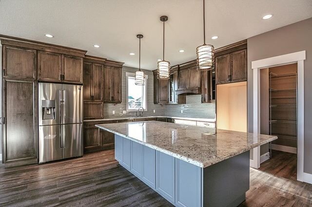 Custom Aquilla kitchen with offset blue island! 
#trending #customhomebuilder #designinspiration #cabinets #kitchen