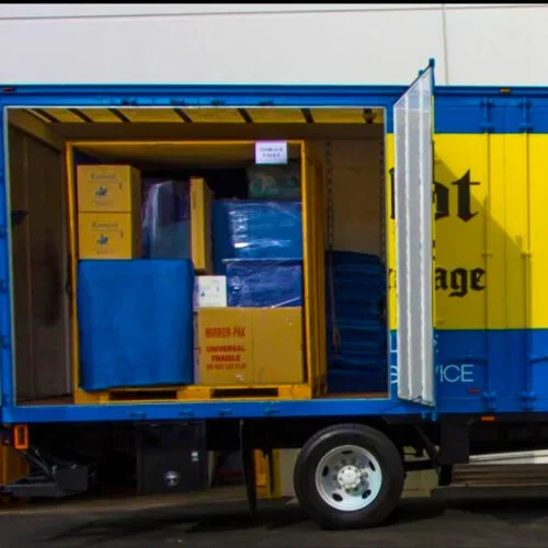 Storage vault container loaded with moving boxes inside a truck.