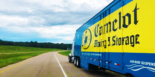 A Camelot Moving truck waits to board a ferry.