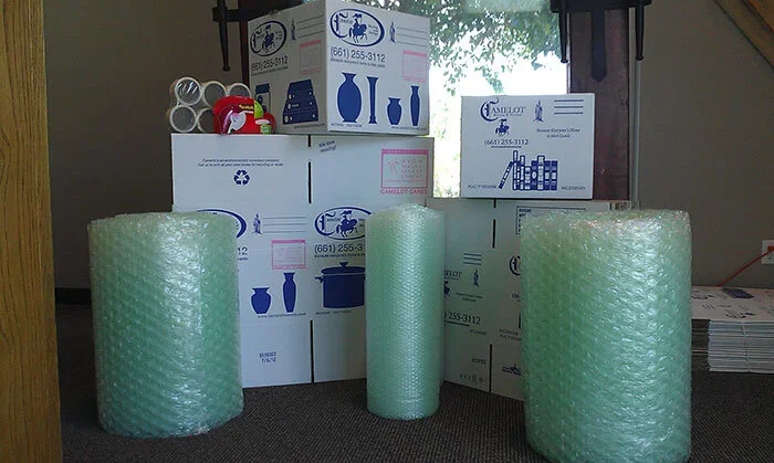 Packing supplies, including boxes, tape, and bubble wrap.