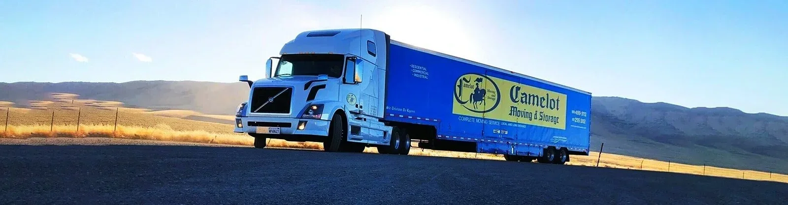 blue‑camelot‑moving‑truck‑landscape.webp