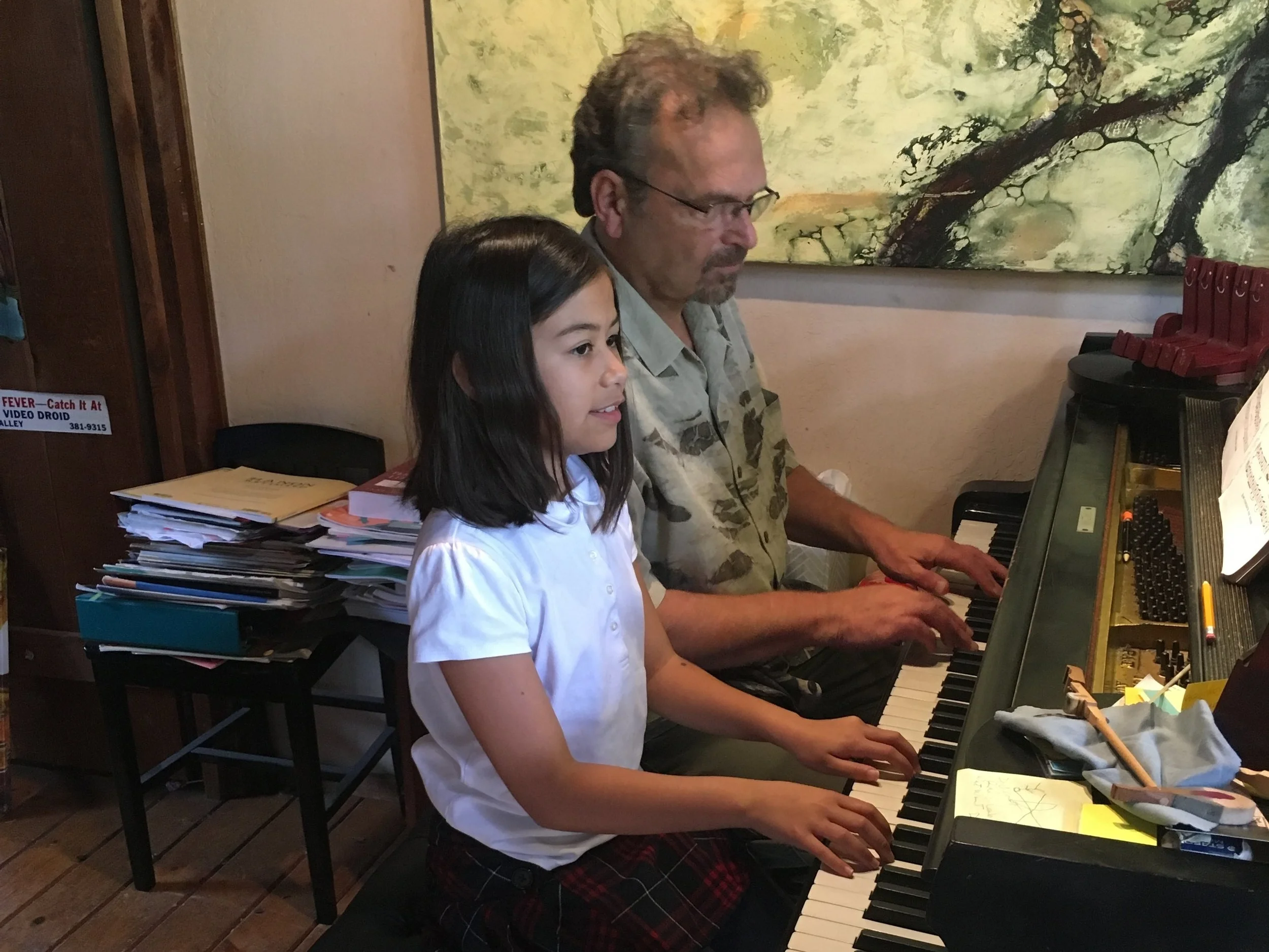 Paul Agricola, Branch President and Mill Valley piano teacher, plays a duet with his student Chloe.